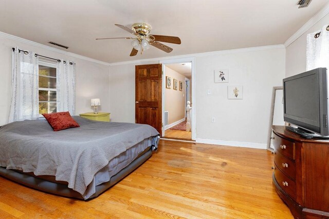 bedroom with light hardwood / wood-style flooring, ornamental molding, and ceiling fan