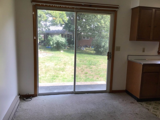 doorway to outside with baseboards, plenty of natural light, and light colored carpet