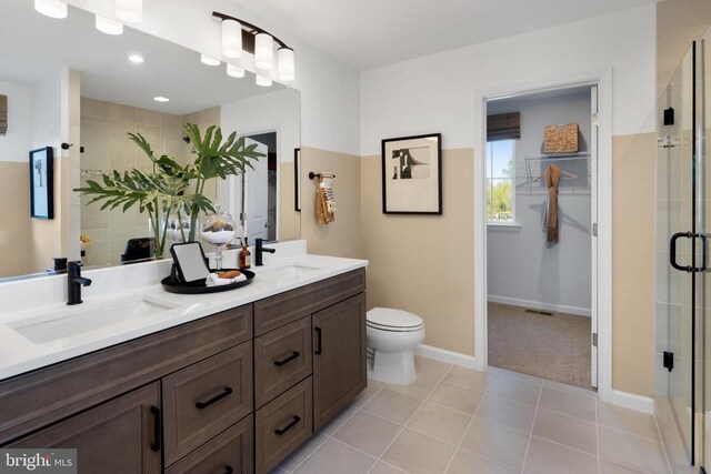 10100 N Streamview Ct, Fredericksburg, VA 22408 - bathroom featuring a stall shower, double vanity, toilet, tile patterned flooring, and baseboards