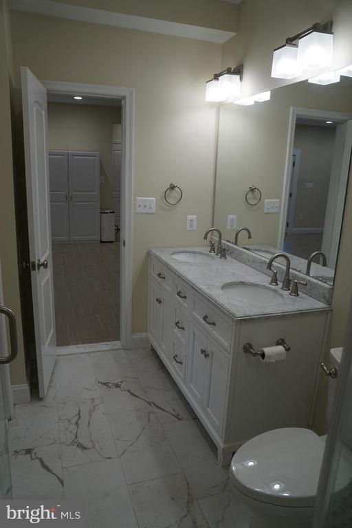 11218 Glen Park Dr, Fredericksburg, VA 22407 - bathroom with marble finish floors, baseboards, and double vanity