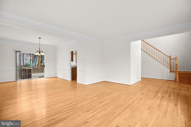 11218 Glen Park Dr, Fredericksburg, VA 22407 - unfurnished living room with a chandelier, light wood finished floors, ornamental molding, baseboards, and stairway