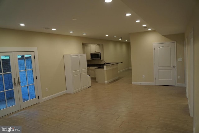 11218 Glen Park Dr, Fredericksburg, VA 22407 - kitchen with stainless steel microwave, recessed lighting, baseboards, french doors, and dark countertops
