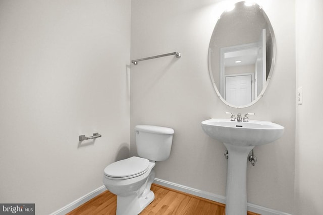 11218 Glen Park Dr, Fredericksburg, VA 22407 - bathroom with wood finished floors, baseboards, toilet, and a sink