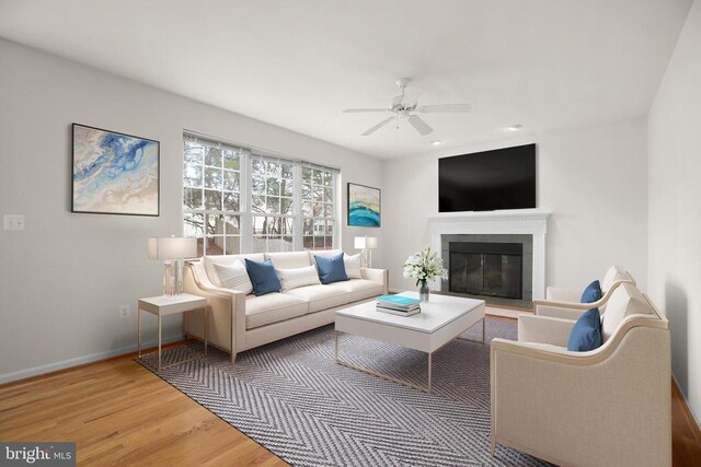 11218 Glen Park Dr, Fredericksburg, VA 22407 - living room featuring a ceiling fan, wood finished floors, baseboards, a glass covered fireplace, and recessed lighting