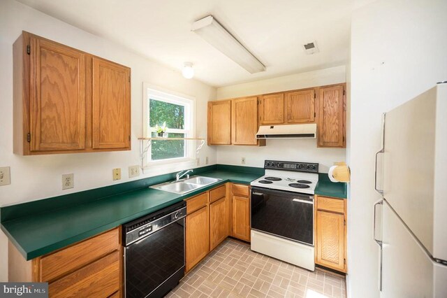 11803 Oakdale Ct, Locust Grove, VA 22508 - kitchen with white appliances, under cabinet range hood, dark countertops, and brick patterned floors