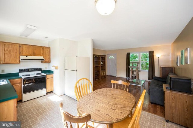 11803 Oakdale Ct, Locust Grove, VA 22508 - kitchen with white appliances, under cabinet range hood, open floor plan, and brick patterned flooring