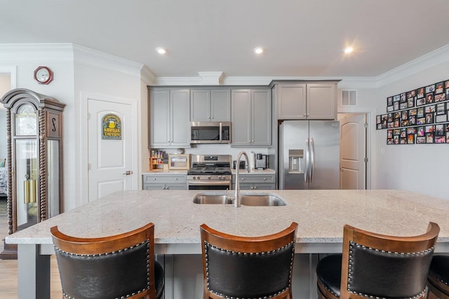 237 Ridgeline Dr, Waynesboro, VA 22980 - kitchen with appliances with stainless steel finishes, a sink, gray cabinetry, ornamental molding, and light stone counters