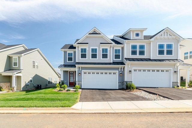 237 Ridgeline Dr, Waynesboro, VA 22980 - view of front facade featuring a standing seam roof, an attached garage, asphalt driveway, a front yard, and board and batten siding