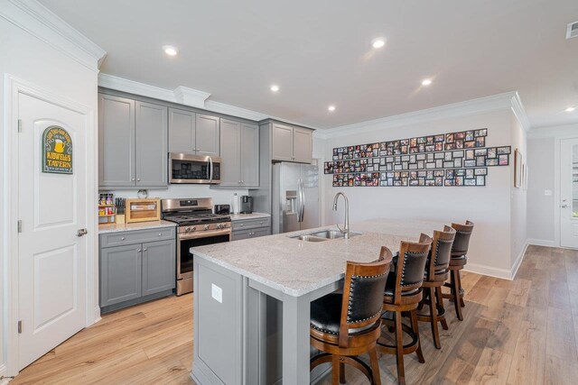 237 Ridgeline Dr, Waynesboro, VA 22980 - kitchen featuring gray cabinets, stainless steel appliances, a sink, ornamental molding, and a breakfast bar area