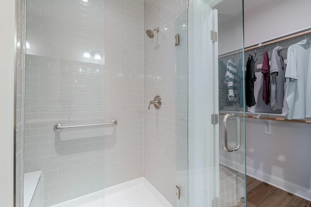 237 Ridgeline Dr, Waynesboro, VA 22980 - bathroom with a shower stall, a spacious closet, wood finished floors, and baseboards