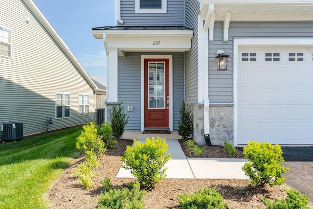 237 Ridgeline Dr, Waynesboro, VA 22980 - property entrance featuring central air condition unit, a standing seam roof, covered porch, a lawn, and stone siding