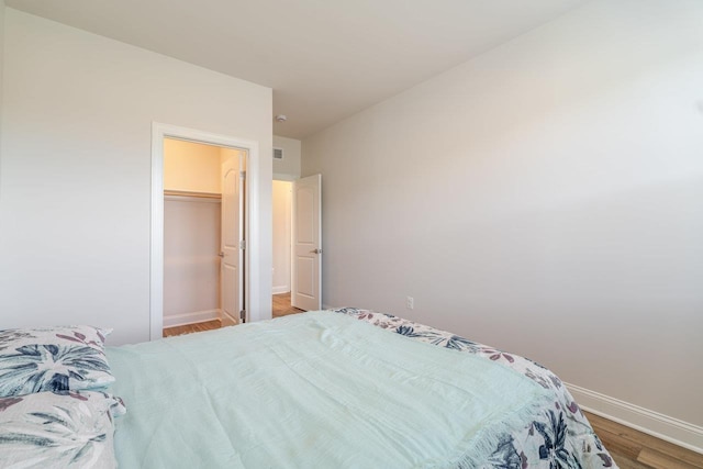 237 Ridgeline Dr, Waynesboro, VA 22980 - bedroom featuring wood finished floors, baseboards, and a walk in closet