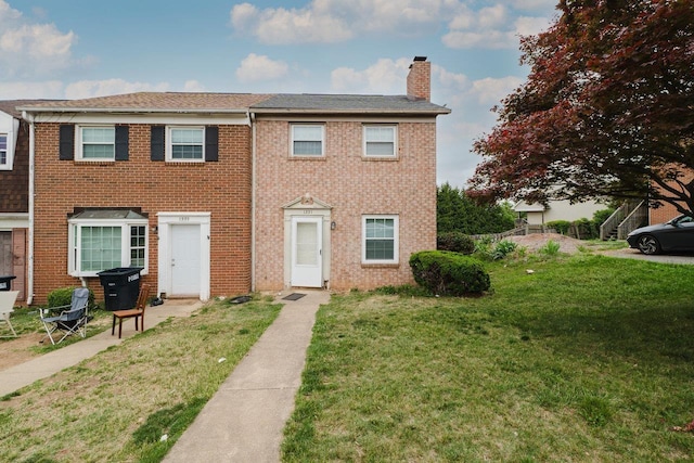 1331 Devon Ln, Harrisonburg, VA 22801 - view of property featuring a chimney, a front lawn, and brick siding