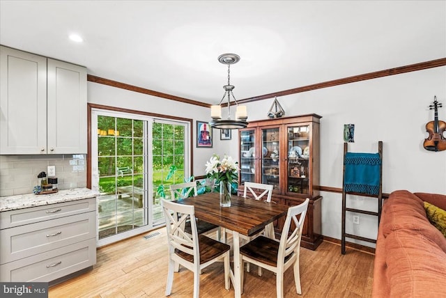 11311 Crown Ct, Fredericksburg, VA 22407 - dining space featuring a chandelier, crown molding, and light wood-type flooring