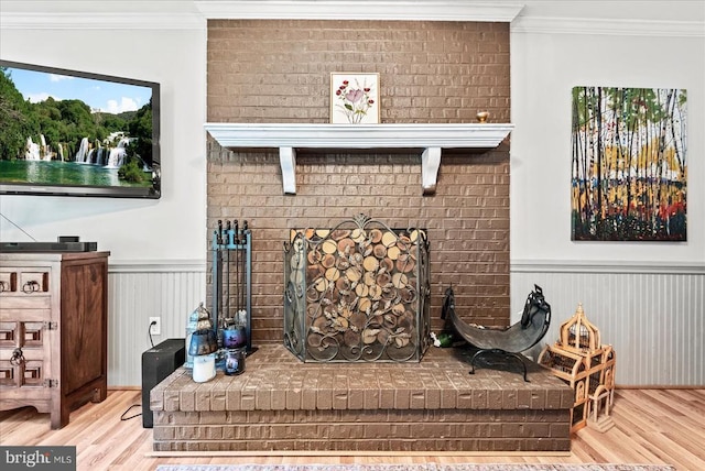 11311 Crown Ct, Fredericksburg, VA 22407 - living area featuring wood finished floors, ornamental molding, wainscoting, and a brick fireplace