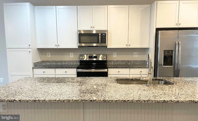 12107 Bowling Farm Ct, Fredericksburg, VA 22407 - kitchen featuring stainless steel appliances, white cabinetry, and light stone counters