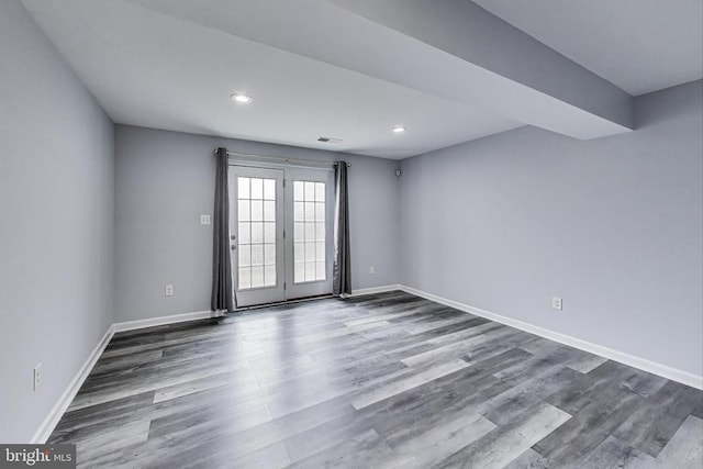 - spare room with dark wood-type flooring and recessed lighting