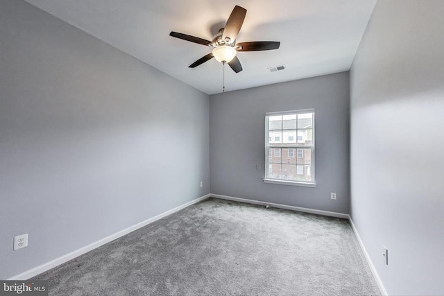  - carpeted spare room with ceiling fan and baseboards