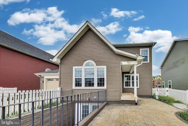  - back of property with a garage and a patio area