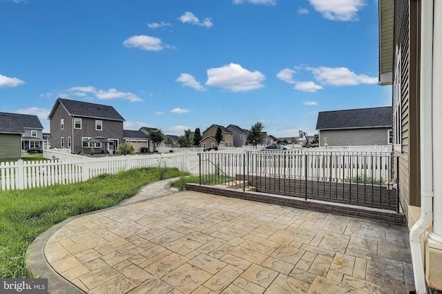  - fenced backyard featuring a residential view and a patio area
