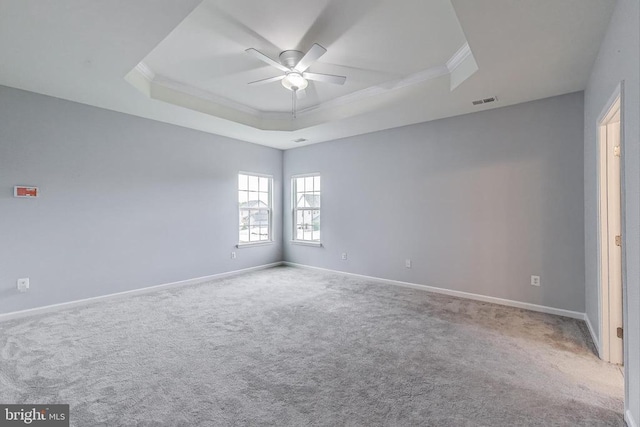  - unfurnished room with a raised ceiling, crown molding, ceiling fan, and carpet floors