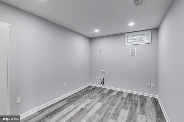  - laundry area featuring wood finished floors and recessed lighting