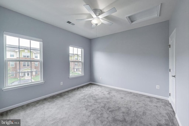  - spare room with carpet floors, attic access, and a ceiling fan