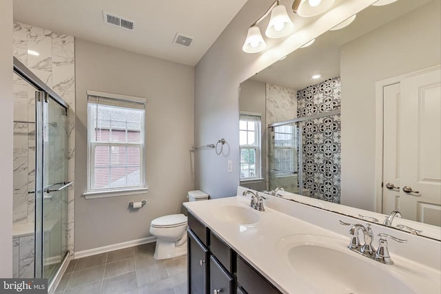  - bathroom with a shower stall, double vanity, and tile patterned flooring
