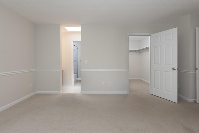 640 Greenwood St, Rockingham, VA 22801 - unfurnished bedroom with a walk in closet, carpet, a closet, and baseboards