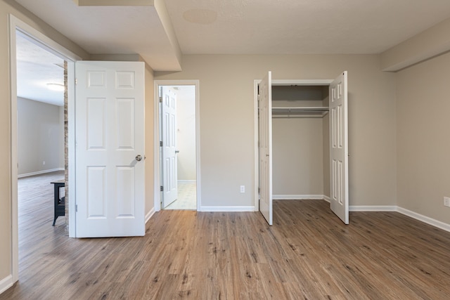 640 Greenwood St, Rockingham, VA 22801 - unfurnished bedroom with wood finished floors, baseboards, and a closet