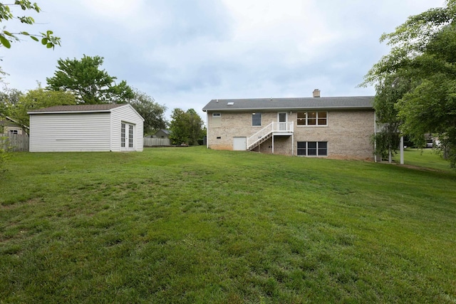 640 Greenwood St, Rockingham, VA 22801 - back of house with stairs, a chimney, a lawn, an outdoor structure, and a wooden deck