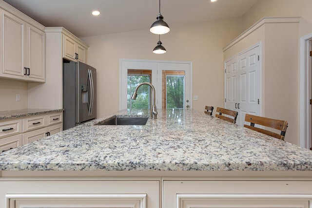 640 Greenwood St, Rockingham, VA 22801 - kitchen with stainless steel fridge with ice dispenser, a sink, light stone counters, recessed lighting, and hanging light fixtures
