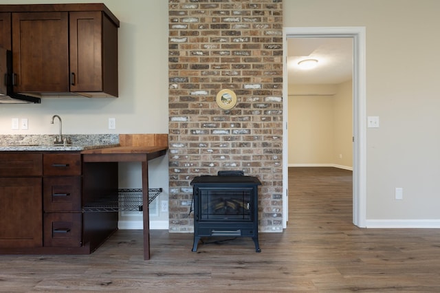 640 Greenwood St, Rockingham, VA 22801 - kitchen with wood finished floors, a sink, dark brown cabinetry, and baseboards