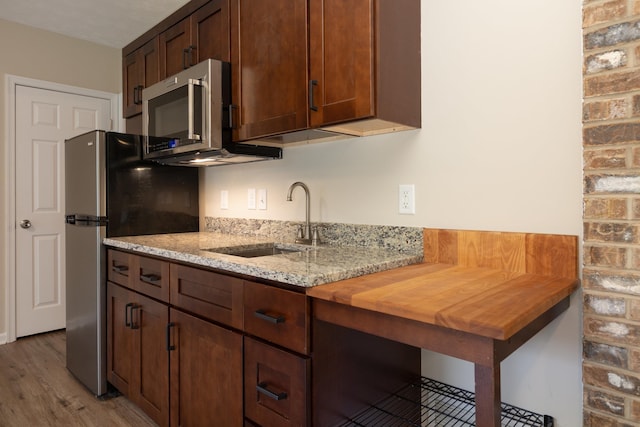 640 Greenwood St, Rockingham, VA 22801 - kitchen with stainless steel appliances, a sink, light wood finished floors, and light stone counters