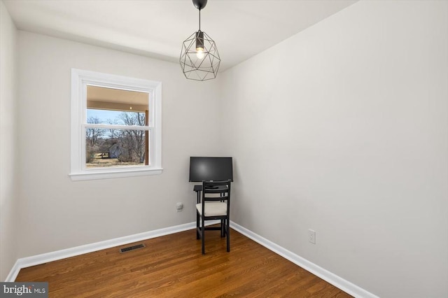 interior space featuring visible vents, baseboards, and wood finished floors