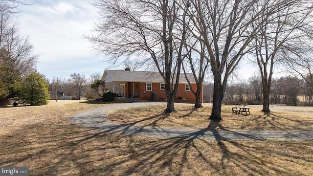 ranch-style house with dirt driveway