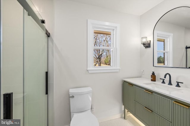 bathroom featuring vanity, a shower stall, and toilet