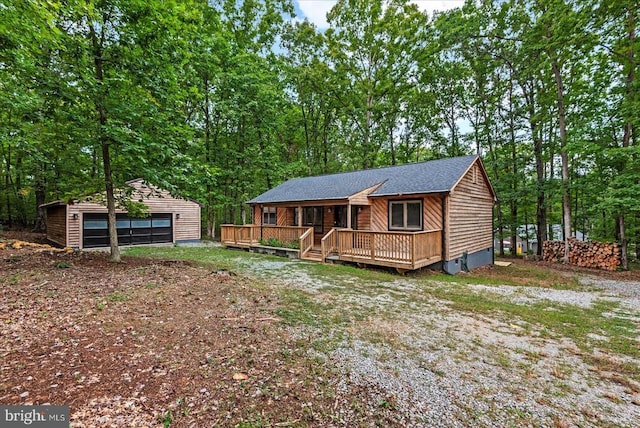65 Wades Run, Mineral, VA 23117 - view of front facade featuring an outdoor structure, a detached garage, crawl space, a deck, and a shingled roof