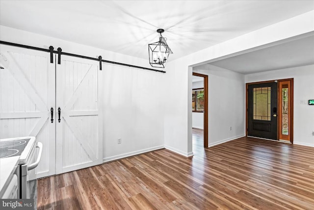 65 Wades Run, Mineral, VA 23117 - unfurnished dining area with wood finished floors, a barn door, baseboards, and a chandelier