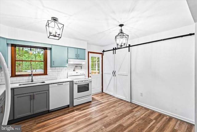 65 Wades Run, Mineral, VA 23117 - kitchen with white appliances, a sink, under cabinet range hood, a chandelier, and backsplash
