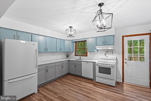 65 Wades Run, Mineral, VA 23117 - kitchen with white appliances, a chandelier, a sink, under cabinet range hood, and healthy amount of natural light