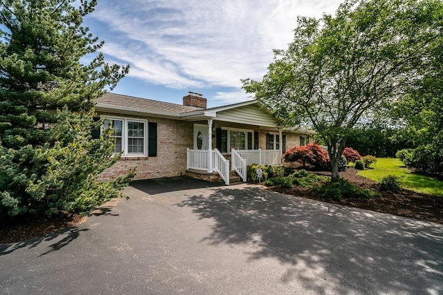 404 3rd St, Grottoes, VA 24441 - single story home featuring covered porch, a chimney, and brick siding