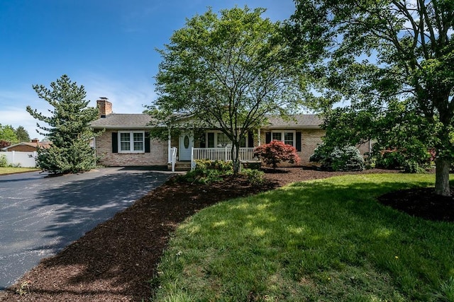 404 3rd St, Grottoes, VA 24441 - ranch-style home with a chimney, covered porch, asphalt driveway, brick siding, and a front yard