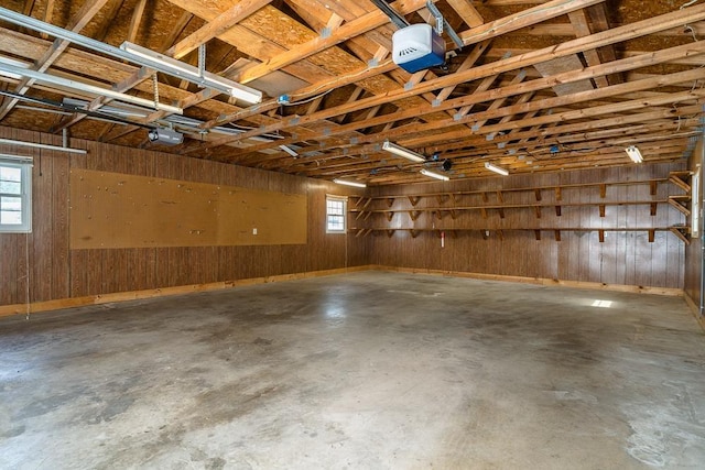 404 3rd St, Grottoes, VA 24441 - garage featuring a garage door opener and wooden walls