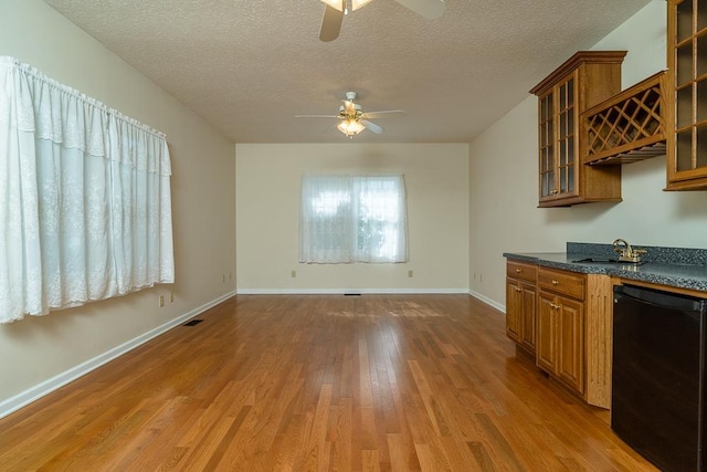 404 3rd St, Grottoes, VA 24441 - kitchen with a ceiling fan, black dishwasher, brown cabinets, and a textured ceiling