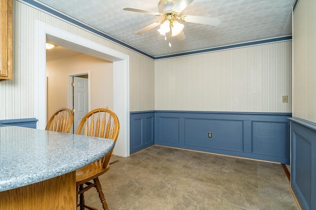 404 3rd St, Grottoes, VA 24441 - dining area with a ceiling fan, a wainscoted wall, and a decorative wall