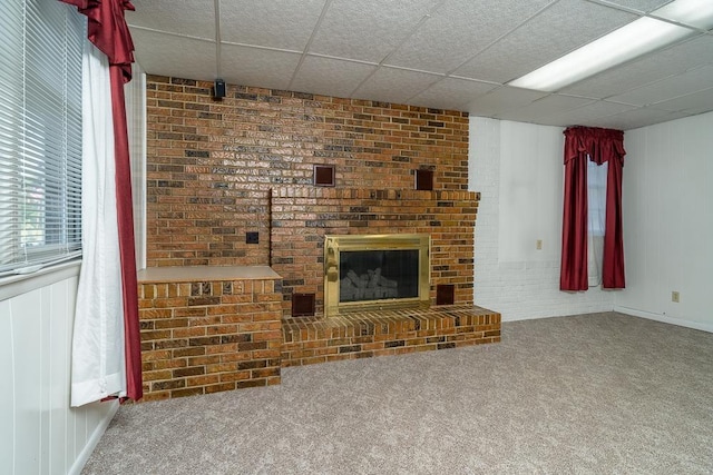 404 3rd St, Grottoes, VA 24441 - unfurnished living room featuring carpet flooring, a brick fireplace, and a paneled ceiling
