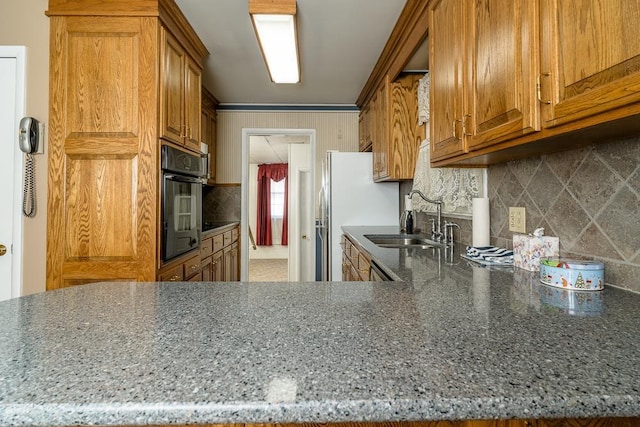 404 3rd St, Grottoes, VA 24441 - kitchen featuring a sink, oven, brown cabinets, and decorative backsplash