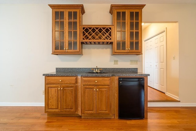 404 3rd St, Grottoes, VA 24441 - kitchen with a sink, light wood-type flooring, brown cabinets, and glass insert cabinets