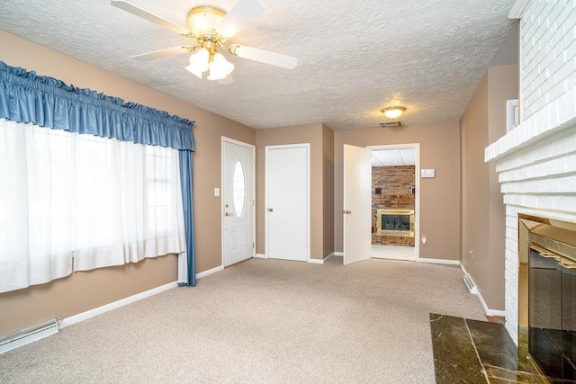 404 3rd St, Grottoes, VA 24441 - entrance foyer with a fireplace, carpet floors, a textured ceiling, baseboards, and ceiling fan